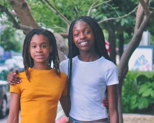 2 young girls posing for a picture